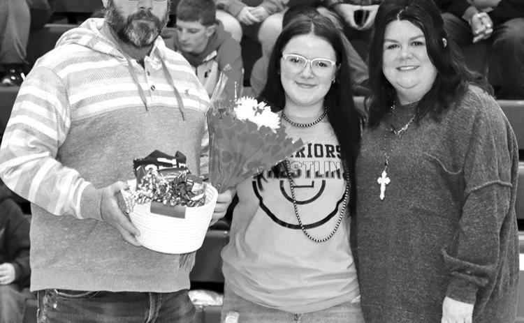 Photo by Mandy Scherer Wrestling manager Lily Cotten with her parent’s on Saturday.