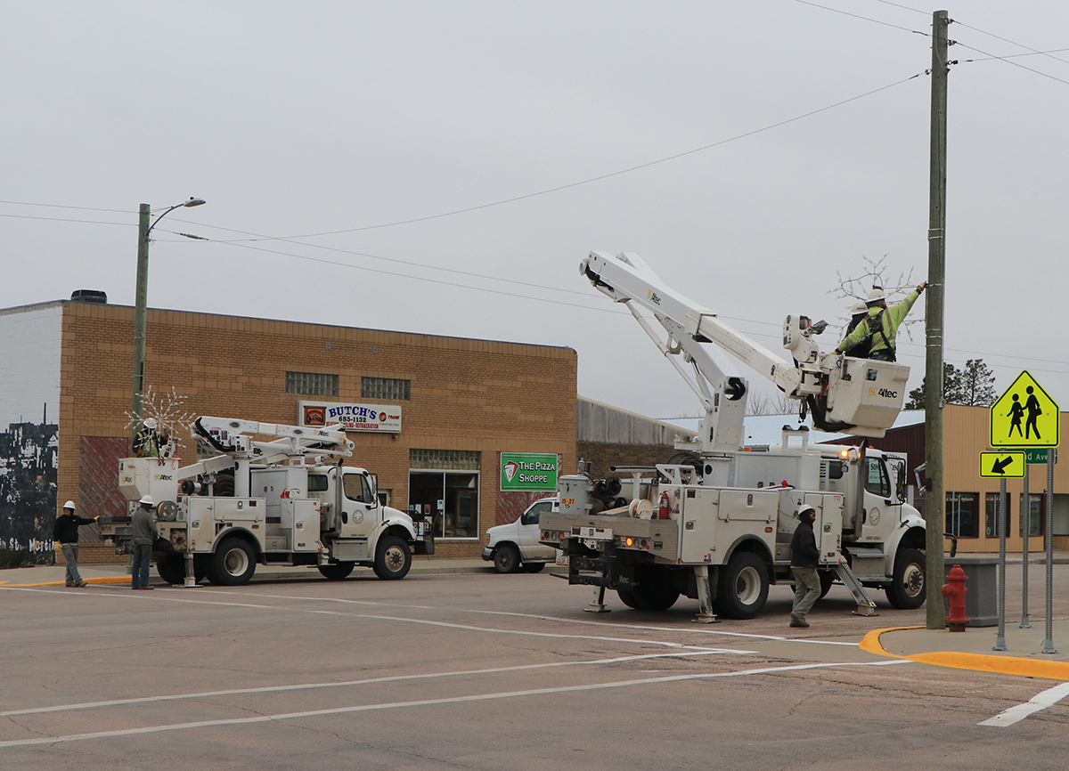 Photo by Taylor Risse  The snowflakes were hung on the light poles with care, in hopes that Christmas would soon be there! Christmas is fast approaching and the Lacreek Electric crew helped Martin get ready for the Christmas season as they hung the snowflakes on Wednesday.