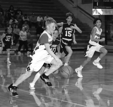 Tayden Boomer races up the court against Winner. Photo by Taylor Risse