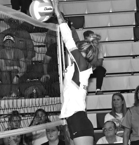 Photo by Taylor Risse. Aubrey Peil gets her hands on a block against Valentine.