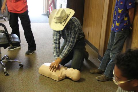 Chevy Novotny practices doing CPR on a mannequin. Photo by Pita Ainslie.