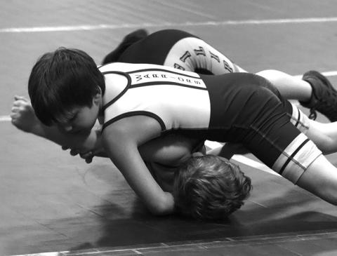 Photo by Melissa Slattery Kase Lesmeister works on a half nelson to get the pin at the Kadoka duals on Friday.