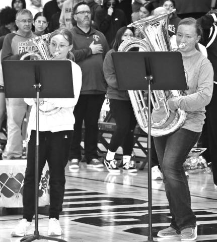Photo by Taylor Risse The “tuba girls” Chloe Louden and Izzy Christensen played the National Anthem at the double headers versus Todd County last week.