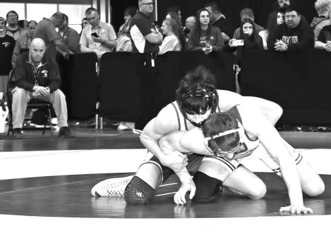Photo by Mandy Scherer Coach Brent Ireland watches as Lyle Noel attempts to breakdown Aiden Schrempp in the first round of the 126 pound weight class at the state tournament.