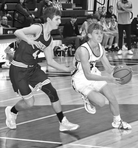 Photo by Mandy Scherer Hayden Risse works the ball toward the basket against New Underwood last Friday evening at home.